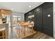 Bright dining room features hardwood floors, dining table, and a modern accent wall at 12843 W Jewell Cir, Lakewood, CO 80228