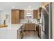 Modern kitchen with an island, stainless steel appliances, and updated countertops and cabinets at 12843 W Jewell Cir, Lakewood, CO 80228