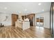 Bright and airy kitchen features an island, stainless steel appliances, and hardwood floors at 12843 W Jewell Cir, Lakewood, CO 80228