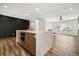 Open kitchen layout featuring an island with additional oven and stainless steel appliances at 12843 W Jewell Cir, Lakewood, CO 80228