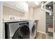 Laundry room with modern washer and dryer, counterspace and storage cabinets at 12843 W Jewell Cir, Lakewood, CO 80228