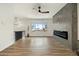 Bright living room features hardwood floors, fireplace, and large window with a view of the neighborhood at 12843 W Jewell Cir, Lakewood, CO 80228