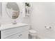 Updated bathroom featuring a white vanity, white fixtures, and modern mirror at 10618 Clearview Ln, Highlands Ranch, CO 80126