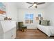 Charming bedroom featuring hardwood floors, a daybed, and a writing desk at 10618 Clearview Ln, Highlands Ranch, CO 80126