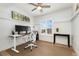 Bright bedroom featuring a ceiling fan, desk, and large window with plantation shutters at 10618 Clearview Ln, Highlands Ranch, CO 80126