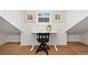 Bright room featuring hardwood floors, a white desk, a black chair, and a small window at 10618 Clearview Ln, Highlands Ranch, CO 80126