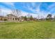 A wide, open green space in a neighborhood with well-maintained homes and mature trees at 10618 Clearview Ln, Highlands Ranch, CO 80126