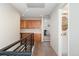 Hallway featuring hardwood floors, black railing, wood cabinets, and a glimpse of a bathroom at 10618 Clearview Ln, Highlands Ranch, CO 80126