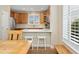 Modern kitchen with wooden cabinets, stainless steel appliances, and a breakfast bar at 10618 Clearview Ln, Highlands Ranch, CO 80126