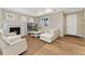 Bright living room featuring a fireplace, hardwood floors, and ample seating at 10618 Clearview Ln, Highlands Ranch, CO 80126