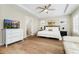 Main bedroom boasts a tray ceiling, fan, a TV, and an en-suite bathroom at 10618 Clearview Ln, Highlands Ranch, CO 80126