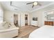 Spacious main bedroom features a tray ceiling, a comfortable seating area, and hardwood floors at 10618 Clearview Ln, Highlands Ranch, CO 80126