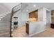 Finished basement area with wet bar, stairs, and a vintage popcorn machine at 10640 Winding Pine Pt, Highlands Ranch, CO 80126