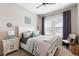 Comfortable bedroom featuring a white bed frame, bedside table, and view of the window at 10640 Winding Pine Pt, Highlands Ranch, CO 80126