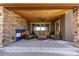 Comfortable, covered patio area with wicker furniture, a ceiling fan, and a Colorado flag at 10640 Winding Pine Pt, Highlands Ranch, CO 80126