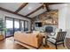 A comfy living room featuring wood accents, a stone fireplace, and sliding doors to the outdoor patio at 10640 Winding Pine Pt, Highlands Ranch, CO 80126