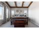 Comfortable bedroom featuring wooden beams and a scenic view through the large windows at 10640 Winding Pine Pt, Highlands Ranch, CO 80126