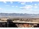 Breathtaking view of the mountains from a house with a stone brick wall in front at 10640 Winding Pine Pt, Highlands Ranch, CO 80126