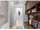 Well-organized mud room area featuring wooden storage and a view of the laundry room at 10640 Winding Pine Pt, Highlands Ranch, CO 80126