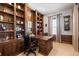 Handsome office featuring custom wood built-ins and a traditional design for a productive workspace at 10640 Winding Pine Pt, Highlands Ranch, CO 80126