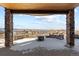 Covered patio offering stunning mountain and neighborhood views, with a stone border at 10640 Winding Pine Pt, Highlands Ranch, CO 80126