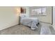 Bright bedroom features neutral carpet, a full size bed, and a large window at 12172 E Kepner Pl, Aurora, CO 80012