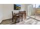 Cozy dining space featuring a wooden table set and large window for natural light at 12172 E Kepner Pl, Aurora, CO 80012