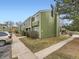 Angle view of the building exterior, showcasing green siding and ample parking spaces at 12172 E Kepner Pl, Aurora, CO 80012