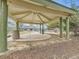 Community gazebo featuring a unique roof design, concrete base, and trash receptacles at 12172 E Kepner Pl, Aurora, CO 80012