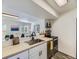 Bright kitchen featuring stainless steel appliances and an open view to the living room at 12172 E Kepner Pl, Aurora, CO 80012