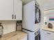 Efficient laundry area with stackable washer and dryer and upper cabinets at 12172 E Kepner Pl, Aurora, CO 80012