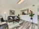 Inviting living area with gray sofa, modern lighting, and an open view to the kitchen at 12172 E Kepner Pl, Aurora, CO 80012