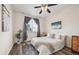 Bright bedroom with a queen bed and window with curtains at 5255 Memphis St # 207, Denver, CO 80239