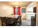 Cozy dining area featuring a modern table set and bright curtains, adjacent to the kitchen at 10050 Holland Ct, Broomfield, CO 80021