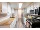Modern kitchen featuring bright countertops, stainless steel appliances, and a functional layout at 10050 Holland Ct, Broomfield, CO 80021