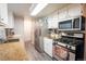 Functional kitchen with stainless steel appliances, granite countertops, and ample cabinet space at 10050 Holland Ct, Broomfield, CO 80021