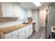 Well-lit kitchen boasts light-colored cabinets, modern stainless steel appliances, and ample counter space at 10050 Holland Ct, Broomfield, CO 80021