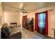 Bright living room with sleek floors, ceiling fan, and large window with decorative curtains at 10050 Holland Ct, Broomfield, CO 80021