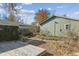 Landscaped backyard with shed, deck, and stone pathway at 3044 Eudora St, Denver, CO 80207