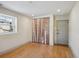 Finished basement room with hardwood floors and birch closet doors at 3044 Eudora St, Denver, CO 80207