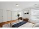 Main bedroom with hardwood floors, large windows, and ample closet space at 3044 Eudora St, Denver, CO 80207