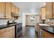 Eat-in kitchen with light wood cabinets and stainless steel appliances at 3044 Eudora St, Denver, CO 80207