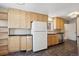 Kitchen with light wood cabinets, granite countertops, and stainless steel appliances at 3044 Eudora St, Denver, CO 80207