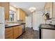 Modern kitchen with light wood cabinets and stainless steel appliances at 3044 Eudora St, Denver, CO 80207