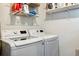 Laundry room with LG washer and dryer and shelving for storage at 3044 Eudora St, Denver, CO 80207