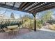 Backyard patio with pergola, table, chairs, and brick wall at 3044 Eudora St, Denver, CO 80207