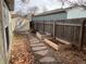 Side yard with a stone pathway and raised garden beds at 3044 Eudora St, Denver, CO 80207