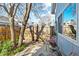 The quaint backyard features a small patio, privacy fence, and mature trees at 6960 S Knolls Way, Centennial, CO 80122