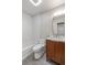 Modern bathroom featuring a tub with white hexagon tiled walls and a stylish wood vanity at 6960 S Knolls Way, Centennial, CO 80122