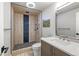 The bathroom features a stylish, modern shower with mosaic pebble flooring and rain shower head at 6960 S Knolls Way, Centennial, CO 80122